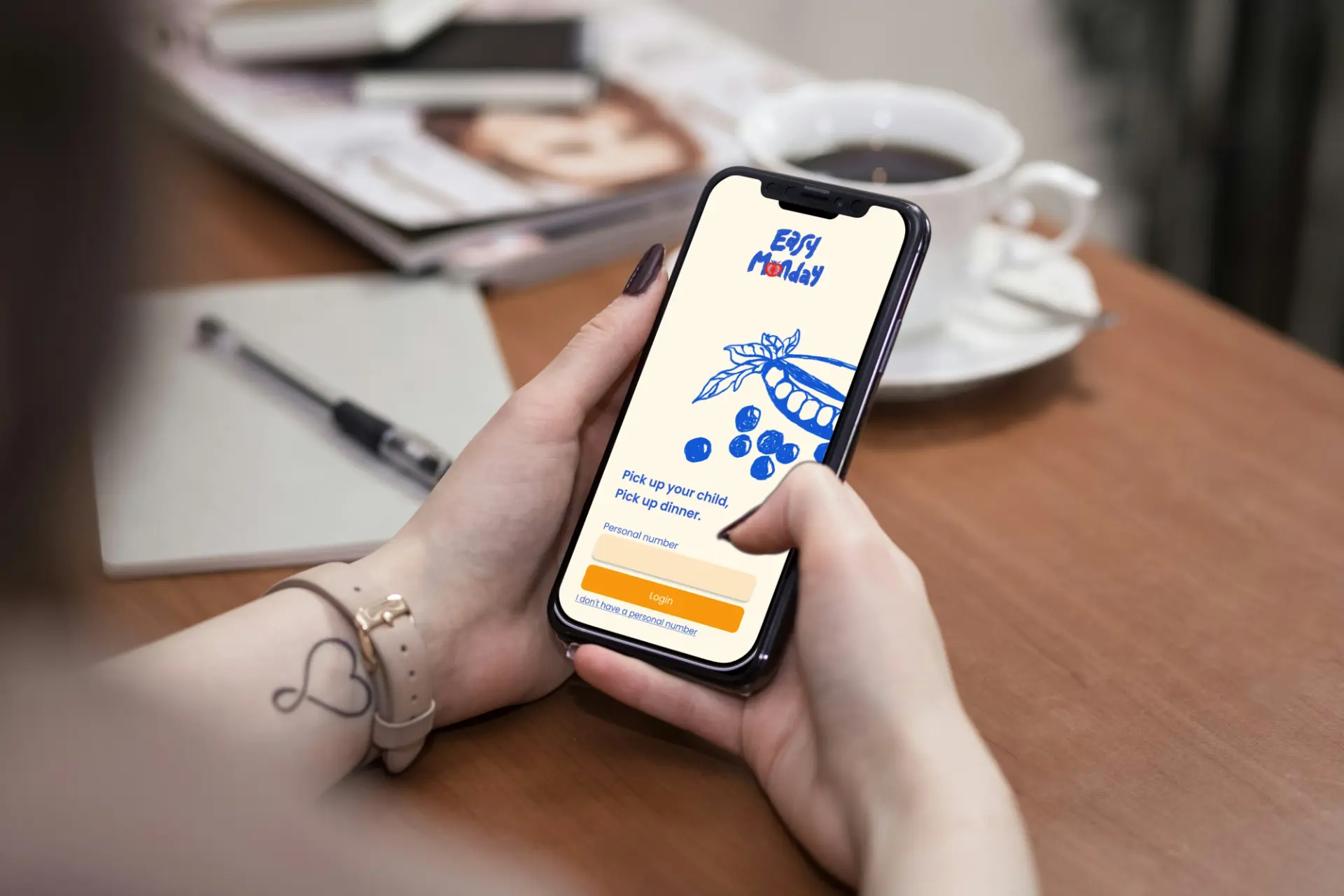 Easy Monday app login screen shown on a phone in hand